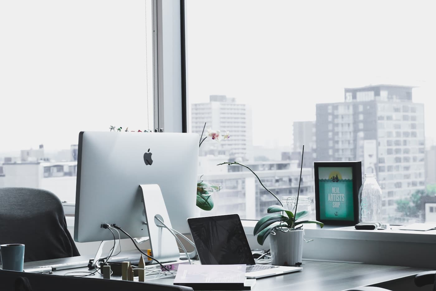 Workspace with monitors and design sketches